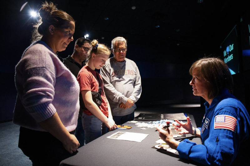 Guests conversing with staff.